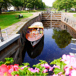 pråmkanal i karlstad med en eka och blommor i förgrunden.jpg